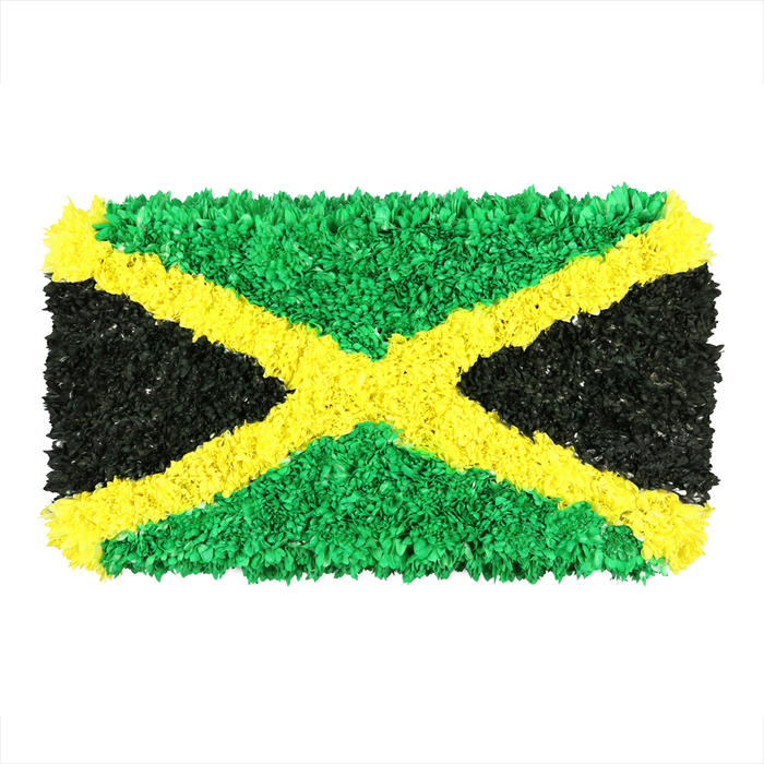 From a quiet Clerkenwell studio, this artistic Jamaican flag draws the eye not with smooth fabric but with a densely textured field built from countless tiny crinkled pieces. The diagonal gold saltire slices the white background with a sunlit glow, while the two top and bottom triangles glow emerald green, vibrant and leafy as a tropical canopy. The left and right triangles present deep, matte black, anchoring the composition with a dignified gravity. Each color segment is composed of innumerable individual scraps, crinkled, pressed, and layered to create a tactile relief that invites a finger to trace its raised ridges. Light travels across the mosaic, catching and releasing on irregular facets, so the flag feels alive, almost breathing as if made by many hands in a shared act of craft. The result is an emblem of heritage, resilience, and creative expression-an artful interpretation ideally placed in features about Jamaica's culture, music, or community art projects. In Clerkenwell, the piece resonates with the craft spirit of Exmouth Market stalls, the street art around Farringdon, and the hands-on makers who turn scraps into statements. It balances celebration with reflection, a symbol of pride that pairs well with stories about festivals, diasporic ties, or local histories. This sculpture-like flag would suit editorial about identity and place, and, for local customers, is available for same-day delivery across Clerkenwell and nearby boroughs, bringing a touch of Caribbean colour to our neighbourhood.