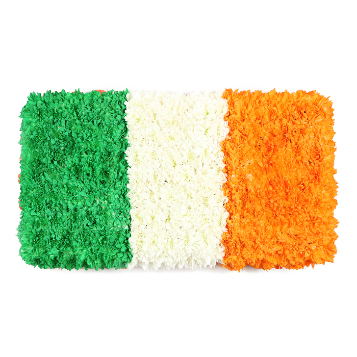 A meticulously arranged, rectangular floral flag presents the Irish tricolor in three equal vertical bands-green on the left, white in the center, and orange on the right-each built from countless small petals that create a lush, textured surface. The green stripe forms a dense, mossy field of blooms, the white band looks like a soft, whispering cloud, and the orange section glows with a radiant, sunlit warmth. Against a clean white backdrop, the petals capture light and shade, emphasizing the flag's precise proportions while still preserving the organic, handcrafted feel. This piece radiates dignity and festivity in equal measure, a tangible symbol of Irish culture and peaceful coexistence, perfect for community events in Clerkenwell near Hatton Garden and Clerkenwell Green. The craftsmanship speaks of a florist's care, with petals aligned to maintain crisp colour blocks and depth that invites a gentle touch. For families and organisations planning gatherings or commemorations, this floral flag offers a heartfelt focal point-delivered with care to locations across Clerkenwell and surrounding areas.