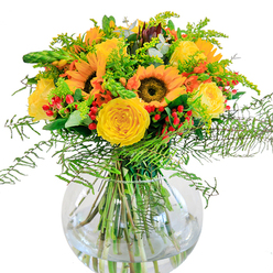 A sun-drenched bouquet designed by skilled florists in Clerkenwell, this arrangement bursts with colour and joyful energy, mirroring the creative buzz around Farringdon's artisan spaces. Dominating the display, sunflowers with luminous yellow petal rays face outward as if seeking the afternoon sun over Smithfield. Their rich brown centers draw the eye, balanced by rosettes of buttery yellow garden roses, whose velvety spirals invite a closer look. Threaded through the golden blooms, bright red hypericum berries pop like little exclamations of delight, offering a subtle nod to Clerkenwell's vibrant market stalls. Wisps of delicate fern fronds soften the edges, their green tendrils flowing downward to provide texture and movement, much like the greenery found in local urban gardens. Supporting stems of pale goldenrod, slender spikes of green, and rounded eucalyptus leaves give the bouquet depth and a hint of modern rustic style. The arrangement sits elegantly in a spherical, clear glass vase, its fresh-cut stems dipping into water that glints beneath soft indoor light. The subtle mingling scent hints at both open meadows and cultivated Clerkenwell terraces. Crafted with sensitivity for special occasions-from birthdays in a sleek loft to anniversaries celebrated near St John's Gate-this bouquet brings a sense of communal warmth and positivity into every space it graces.