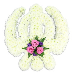 A striking Khanda floral tribute fills the frame, its instantly recognisable Sikh emblem meticulously shaped from tightly packed white chrysanthemums so that every curve and blade is clear. The central double-edged sword rises upright, framed by the circular chakra, while the two kirpans sweep outwards in perfect balance, all rendered in the same creamy white blooms that give the whole piece a soft, cloud-like texture. The flowers sit densely together, almost hiding their individual stems, so the symbol appears smooth and continuous, like a single form fashioned from living snow. At the base of the design, between the tips of the kirpans, a delicate posy adds a tender note of colour: three blush-pink roses, fully open yet still fresh, rest among smaller violet and deep purple flowers, with light and dark green foliage tucked underneath. Their colours glow gently against the white, suggesting love, memory, and a touch of comfort amid grief. The tribute is photographed against a plain white background, with soft, even light that highlights the subtle shadows between the petals and emphasises the clean outline of the Khanda. It feels calm and contemplative, as though prepared for a quiet service in a local Gurdwara near Clerkenwell Green or a farewell gathering in one of the area's historic chapels. Made by skilled florists familiar with Sikh funeral traditions in central London, this arrangement seems intended to rest beside the casket or at the front of the service, a faithful symbol of devotion and respect offered on behalf of family and friends.