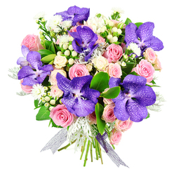 Presented against a crisp white background, this elegant bouquet appears almost like a still-life painting brought into the present day, its colours and forms carefully balanced by a florist who understands both drama and restraint. Dominating the arrangement, generous Vanda orchids unfurl in deep purple-blue, each petal veined and speckled with lighter tones, giving a sense of movement and tropical opulence. Nestled around them, blush-pink roses span every stage of bloom-from tightly wrapped buds that hint at promises yet to come, to open, spiral-centred flowers that feel full of tenderness and warmth. Creamy white spray roses are tucked in as soft accents, lending a gentle, cloud-like effect that lightens the composition. Between the larger blooms, tiny white aster-style flowers and neat clusters of ivory hypericum berries bring a delicate, almost dewy texture, reminiscent of early-morning walks through Spa Fields or along Clerkenwell Green when the air is cool and fresh. Silver-grey dusty miller foliage adds a velvety, frosted note, contrasting beautifully with the glossy dark green leaves that lend structure and depth. The stems are bound together with a semi-sheer ribbon that shimmers in shades of silver and lilac, echoing the orchids' cool, regal tones. Everything is arranged in a rounded, hand-tied style that feels both luxurious and approachable, perfect for sending thoughtful congratulations to a new office near Farringdon, offering an elegant birthday surprise, or marking a romantic moment in one of Clerkenwell's converted warehouse apartments, where the bouquet's purples, pinks, and whites quietly radiate affection and grace.