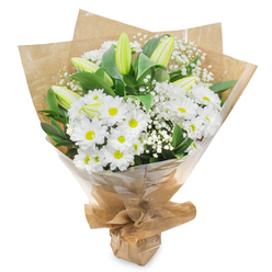 A serene white and green bouquet is photographed front-on against a pure white backdrop, every stem carefully placed to create a sense of calm and order that feels at home in Clerkenwell's tranquil side streets. The heart of the design is a profusion of white chrysanthemum blooms, each one daisy-like with fine, layered petals surrounding a fresh yellow-green centre, suggesting a subtle glow of hope. These flowers sit closely together, forming a gentle, cushion-like texture that invites the eye to rest. Rising through the chrysanthemums are elongated lily buds, still firmly closed, their smooth pale green casings tipped with hints of creamy white, poised like quiet promises of blossoms yet to come. Delicate sprays of baby's breath weave between the larger flowers, dozens of tiny white stars floating on slender stems, adding a soft, misty lightness. Around the outside, lush deep-green foliage fans out, its slightly waxy surface catching the light in small highlights that enhance the crispness of the white petals. The bouquet is wrapped in a sleeve of rustic brown kraft paper, its natural creases and folds suggesting a handmade, artisanal touch, then finished with a clear cellophane layer that hugs the stems and reflects a gentle shine. The base is neatly gathered and tied, forming a compact, easy-to-hold bundle, as if just prepared for delivery to a home off Clerkenwell Road or a quiet office near Farringdon. This thoughtful composition feels especially fitting for sympathy, remembrance, or sending comfort during a difficult time, offering a peaceful visual presence even in the smallest London flat.
