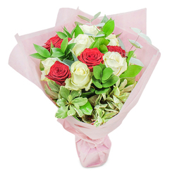 This Clerkenwell bouquet, expertly composed in a local studio just steps from Farringdon Station, is an ode to both romance and artistry. A perfect balance of deep scarlet and creamy white roses emerges, each flower positioned to highlight its neighbour's contrast. The red roses pulse with emotional intensity, petals rich and softly scented, while the white roses are crisp and luminous, suggesting new beginnings. Interspersed among the roses, you'll find a tapestry of greenery: glossy ruscus with its deep hues, round-leafed accents that soften the composition, and lightly variegated foliage lifting the whole with subtle hints of cream, all bound together by sprigs of silver eucalyptus that seem to dance in the London light. The bouquet is gently embraced by translucent, blush-pink wrapping, tied neatly for a finish as tidy as the well-kept squares of Clerkenwell. There's an undeniable sense of anticipation-a bouquet suited to celebrating milestones, igniting anniversaries, or marking spontaneous gestures, sent from one of your favourite local florists. Each scent and texture is thoughtfully curated, evoking the atmosphere of Clerkenwell's creative spirit-a blend of heritage, contemporary style, and heartfelt emotion.