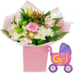 Seen against a clean white backdrop, this baby girl celebration arrangement feels like a little pocket of joy, the sort of gift a family in Clerkenwell might have delivered after a first trip home from the maternity ward. A square, pastel pink gift box anchors the design, its simple, modern shape echoing the calm lines of local townhouses. From this box, layers of clear cellophane and soft pink tissue fan out, catching the light and giving the impression of silky fabric or wrapping paper that has just been carefully opened. Rising from this base is a generous bouquet that mixes texture and tone with a florist's practiced eye. At its centre glows a single bright pink gerbera daisy, the focal bloom whose open face seems to smile. Around it, fluffy white chrysanthemums create a soft halo, their dense petals evoking cotton-wool clouds. Threaded through are stems of delicately speckled alstroemeria in blush and white, their slender petals curling back to reveal fine markings. A few creamy yellow lily buds lift above the other flowers, their closed forms full of promise. Nestled among them, lime-green button-style blooms and glossy red hypericum berries bring contrast and a hint of woodland richness, while deep green leaves and airy fern fronds extend the arrangement outward in gentle arcs. To the right, a shiny foil balloon in the shape of a baby pram adds a playful, unmistakable message: painted in bright pink with a plump purple hood and purple wheels, it carries the words "It's a Girl!" in bold yellow and green lettering, with tiny hearts decorating its side. The overall scene feels fresh and celebratory, like spring light over Clerkenwell Green, and conveys tenderness, pride, and excitement for a new arrival, ideal for baby showers, hospital deliveries, or welcoming a newborn home to a city flat.