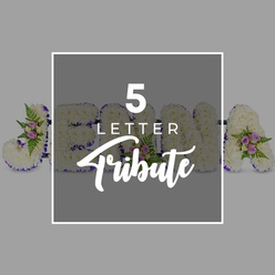 In this detailed image, a custom five-letter floral tribute is arranged in a clean, graphic composition, set on a pale grey background that allows every petal to stand out with clarity. The freestanding letters, partially spelling out a name with shapes that resemble "J", "O", "H", "N" and "A", are completely carpeted in tightly packed white chrysanthemums. Their small, rounded florets create a plush, almost quilted surface, suggesting softness and quiet tenderness. Each letter is precisely edged with a band of deep purple satin ribbon, the rich colour adding poise and solemnity, while the faint shimmer of the fabric catches the light. At intervals along the tribute, small posies of accent flowers rest on the chrysanthemum base: blush pink and mauve spray roses with layered petals, accompanied by airy green fern fronds and a touch of foliage that adds depth and a natural, garden-like feel. A square overlay, slightly darker grey than the background and framed in white, sits at the centre of the image. On it, the text "5 LETTER Tribute" appears in white, with the words "5 LETTER" in clean, uppercase type and "Tribute" in a flowing script, clearly indicating the design is intended for personalised funeral or memorial wording. The look is polished yet gentle, like something you might see prepared for a quiet service near Clerkenwell Green or one of the area's historic meeting houses. The arrangement radiates calm remembrance and thoughtful craftsmanship, expressing a dignified farewell through simple, harmonious colours and textures.