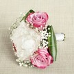 A romantic bouquet, expertly composed in the heart of Clerkenwell, is gently poised on a subtly woven ivory fabric-its neutral surface recalling the understated elegance of the area's boutique cafés. Three vibrant pink roses, their petals flushed with gradations from magenta to hushed blush and pale lavender, nestle among lush, ruffled white peonies that evoke the early spring blooms in St John's Gardens. Fluffy sprigs of baby's breath interlace the arrangement, lending an airy, delicate grace and a touch of whimsy, akin to the playful spirit of Clerkenwell's creative quarters. Deep green, slightly glossy leaves embrace the bouquet's base, enhancing the vivid colors and lending a crisp, modern silhouette. The hand-bound stems, wrapped smoothly in white satin, speak to careful craftsmanship and the intention behind each bloom-qualities cherished by Clerkenwell Flowers. Gentle, natural light reveals every intricate petal and subtle sheen, conjuring a scene of love and fresh beginnings ideal for weddings at local venues, vow renewals, or cherished celebrations across central London. This bouquet's fragrant, soft presence lingers, making it as perfect for marking new chapters as for celebrating heartfelt milestones within the vibrant Clerkenwell community.