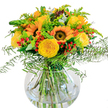 A celebration of sunny days in Clerkenwell, this stunning bouquet is a jubilant mix of golden yellow roses and radiant sunflowers, thoughtfully gathered by local florists with an artist's touch. The vibrant arrangement is showcased in a crystal-clear, round glass vase that allows every stem and leaf to shine-much like the heritage buildings along Clerkenwell Road. Between proud, bright sunflowers and open, buttery yellow rose blooms, delicate greenery unfurls in sinuous curves, echoing the movement of a gentle breeze over Spa Fields. Scarlet hypericum berries are woven throughout, offering playful splashes of colour that lift the whole design. Fern fronds and lush filler greens add volume and texture, cascading subtly towards the table and providing a nod to Clerkenwell's leafy corners. Stems crisscross visibly in the clear water, adding a sense of natural artistry and freshness. The air around the bouquet is softly perfumed, hinting at the familiar scent of London parks in summer. Light glances off the petals, casting quiet, contented shadows-evoking the ambiance of an easy afternoon in one of the area's cafes. This bouquet is perfect for marking happy milestones, brightening an office near Farringdon station, or simply bringing a touch of Clerkenwell radiance into any home.