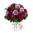 A lush, hand-arranged bouquet of deep crimson and soft lavender roses, densely gathered into a rounded, painterly dome that feels both romantic and quietly joyful. The roses are fully open, their velvety petals unfurling in layered spirals: the reds range from rich burgundy to true crimson, while the purples sit in the gentlest lilac and dusty mauve tones. Nestled among the blooms are small clusters of bright red-orange rose hips that catch the eye like cheerful punctuation, their glossy skins and knobbly textures offering a contrast to the satiny softness of the petals. Dark green foliage - likely Ruscus or Salal - threads through the arrangement, its matte, elongated leaves creating depth, framing each bloom, and giving the bouquet a fresh, garden-picked silhouette.

The flowers sit in a rounded mercury-effect glass vase with a mottled, antique-silver sheen that reflects light in subtle, softened highlights. The vase narrows slightly at the neck and is finished with a natural raffia tie and a small white gift tag decorated with a simple stylised rose graphic and green script, suggesting a thoughtful, personal gift. Photographed against a clean white background, the bouquet's saturated hues and the vase's reflective surface stand out crisply, as if lit by soft morning light filtering through a Clerkenwell window.

This arrangement radiates warmth and considered craftsmanship - a perfect choice for anniversaries, quiet celebrations, or to send a sincere message of gratitude. It evokes the calm of a local florist's counter near Exmouth Market or Leather Lane, freshly prepared and ready for local delivery across Clerkenwell and neighbouring streets.