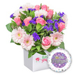 From a sunlit corner of Clerkenwell, this celebratory floral gift shines inside a sleek, pure white square presentation box. The box's front bears a small red rose emblem and fresh green typography, hinting at quality and care from a local florist. Inside, a bountiful bouquet unfolds: soft pink roses, their petals ranging from tight buds to fully opened blooms, exude classic romance; interspersed are pastel pink gerbera daisies with crisp white edges and pale yellow centers, their radiance like little suns. Scattered throughout are clusters of vivid purple filler flowers-statice or limonium-adding depth and texture and a regal contrast to the tender pinks. Lush green foliage in varying shades frames the arrangement, lending a garden-fresh, natural feel that makes every leaf seem to glow in the light.

A round foil balloon peeks in from the bottom right, a glossy accent designed for the engagement moment. The balloon features a central purple circle bearing the words You're Engaged! in bold silver lettering, with a gleaming golden ring substituting the 'O' in You're, a playful nod to the occasion. The outer white ring is studded with tiny hearts in pink, blue, purple, and grey, and sprinkled with tiny silver stars that catch the eye as the bouquet moves. This composition is ideal for congratulating a newly engaged couple in Clerkenwell, whether placed on a dining table near Exmouth Market or delivered to a home near Farringdon Road. It speaks of happiness, new beginnings, and the warmth of intimate celebration, and it can be arranged for same-day delivery across Clerkenwell and surrounding neighbourhoods, bringing bright joy to the couple's space.