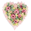 A pastel heart-shaped floral arrangement is presented on a clean white background, its composition evoking peaceful remembrance and tender affection. The heart's outline is softened and defined by a pale pink satin ribbon, which encircles the design in a continuous loop and ties into small, refined bows at the top and lower tip, bringing a touch of quiet elegance. Inside this ribbon frame, the heart is densely filled with layers of pink lisianthus and soft, frilled carnations, their ruffled petals overlapping to create a deeply textured surface that appears as plush as velvet. Creamy yellow and pale ivory spray roses are scattered through the pink, their smaller heads opening into gentle rosettes that add warmth without overpowering the pastel palette. Here and there, tiny white daisy-like blossoms with bright yellow centres peek out, reminiscent of chamomile and lending a natural, country-garden feel, as if the arrangement might have been assembled after an early morning walk through a London park. Eucalyptus sprigs, in soft silvery-green tones, meander between the blooms, their rounded leaves adding both a contemporary note and a sense of calm, while darker green variegated foliage deepens the composition and accentuates the heart shape. The arrangement feels both full and carefully controlled, balanced in colour, texture, and form, much like the blend of historic and modern spaces around Exmouth Market in Clerkenwell. Designed as a sympathy tribute, this floral heart would sit beautifully beside a coffin, memorial table, or book of condolence, quietly expressing love, respect, and support during moments of grief.