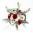 There is a subtle poetry in this Clerkenwell-inspired bouquet, illuminated from above against a flawless white backdrop that highlights every nuance. Luxurious, deeply red roses unfold at the heart of the arrangement, radiating warmth and a subtle promise of lasting affection-a tribute to the area's romantic nooks and hidden gardens. Intertwined are crisp white gerbera daisies with bold, dark centers; their confident faces brighten the composition and evoke the artisanal spirit of Clerkenwell's renowned markets. Wispy clouds of small white spray chrysanthemums lend delicate softness and a touch of movement, recalling gentle morning breezes along Clerkenwell Road. Wisps of soft lilac lisianthus peek from the blooms, offering a cooling, serene counterpoint to the richer shades and inviting a sense of peace. Silvery eucalyptus leaves, with their signature round silhouette, unfurl around the edges, imparting a sense of modern freshness, their subtle scent melding harmoniously with each petal. Additional strands of slender greenery provide structure and balance, ensuring that every flower is showcased to its fullest. This bouquet embodies joyful celebration and quiet reflection, carefully composed with an eye for both beauty and meaning, ready to bring local charm and grace into the homes of Clerkenwell's vibrant community.