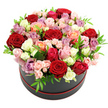 A chic black hat box filled to overflowing with roses is set alone against a bright white backdrop, creating a dramatic, gallery-like presentation. The arrangement rises in a rounded dome, so densely packed with petals that the flowers seem to form one continuous, cloud-like surface. Deep red roses create pockets of intensity throughout the design, their velvety, layered petals evoking passion and classic romance. Between them, softer tones of blush pink, creamy white, and pale peach add a tender, almost nostalgic charm, like the softer side of Clerkenwell glimpsed in quiet side streets off Clerkenwell Road. Brighter fuchsia and coral roses punctuate the composition with splashes of energy, while elegant lavender and mauve blooms introduce a cool, contemporary edge that suits the area's creative studios and design houses. Smaller spray roses are nestled among the larger heads, some tightly budded and others just beginning to unfurl, introducing variety in scale and suggesting a bouquet at the peak of freshness. Fine, bright green leaves weave throughout, their crisp colour offering a lively counterpoint to the warmer petals and giving the eye gentle pauses amid the richness. The hat box itself is smooth and rounded, coloured a deep black with a slender red trim circling the base, a detail that subtly echoes the deeper roses above and adds sophistication without drawing focus away from the flowers. With its clean white background and soft, shadowless lighting, the photograph highlights the intricate structure of the arrangement and the care taken in every placement. It feels like a refined, yet heartfelt gift, ideal for anniversaries, romantic surprises, or special celebrations delivered to Clerkenwell flats, townhouses, or offices near Farringdon and Hatton Garden.