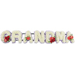 The photograph captures a touching floral tribute spelling out GRANDMA in tall, block-style capital letters, all aligned in a single, graceful row against a bright white background that highlights every detail. Each letter is composed of tightly clustered white cushion chrysanthemums, or similar small, rounded blooms, creating a smooth, soft-looking surface reminiscent of freshly fallen snow. Around the perimeter of each letter, a soft edging of pale purple ribbon or backing forms a delicate border, adding dimension and a gentle hint of colour without disturbing the calm, neutral palette. Carefully placed red accents bring warmth and emotional focus: the G is adorned with a small arrangement of deep red roses and a striking red-and-white calla lily, tucked neatly into the curve of the letter. The first A is embellished with a single red anthurium, its glossy, heart-shaped form shining against the white flowers. At the centre, the M carries another cluster of red roses alongside a second red anthurium, while the final A echoes that gesture with one more anthurium bloom. A discreet dark green frame supports the letters, barely visible but essential for keeping the tribute steady for display at a funeral or memorial. This is the kind of bespoke funeral lettering often created by Clerkenwell florists for families around Farringdon, Hatton Garden, and nearby City streets, a personalised floral arrangement intended to sit by the coffin, at the front of a chapel, or on a graveside in honour of a much-loved grandmother, expressing love, remembrance, and gratitude through flowers.