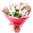 A striking hand-tied bouquet featuring majestic white lilies and deep red roses is displayed against a clean white background, as if perched on the counter of a Clerkenwell florist's studio on a bright morning. The lilies form the dominant focus, their trumpet-shaped blooms opening wide to show delicately curved white petals and prominent central stamens tipped with dark rust-brown anthers. Some lilies are fully open, while others remain enclosed in smooth, green buds, hinting that the bouquet will continue to change and unfold over the coming days. Threaded between these elegant blooms are numerous red roses, many still in tight bud, with layered petals that look almost velvety to the touch, offering a rich counterpoint to the cool purity of the lilies. A backdrop of abundant foliage surrounds the flowers-the leaves ranging from broad, deep green blades with a polished sheen to slender, spiky greenery that flicks outward, adding dynamic lines and depth. The stems are wrapped generously in shiny, bright pink cellophane or floral paper, gathered into soft, fluid folds that reflect the light and give the impression of movement, like fabric caught in a gentle breeze. At the base, a slim lime green ribbon is tied neatly, adding a fresh twist that echoes the greenery and contrasts playfully with the pink wrapping. The mood is joyful and romantic, perfect for same-day delivery to an office near Farringdon Station, a loft apartment off Clerkenwell Road, or a quiet celebration at home, conveying affection, appreciation, and a sense of thoughtfully chosen beauty.