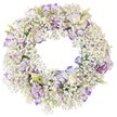 A softly luminous circular wreath of white and lilac flowers is captured against a clean, white background, allowing its tranquil beauty to be appreciated in full. The ring appears almost weightless, built from an abundance of fine Baby's Breath that wraps continuously around the frame. Each tiny white flower contributes to a cloud-like texture, creating a gentle halo of light around the wreath. Nestled within this delicate mist are clusters of Lisianthus, whose petals curl and ripple like finely pressed silk. The blossoms are primarily white but tipped and edged with shades of lavender, mauve, and violet, giving a subtle wash of colour that moves rhythmically around the circle. Some flowers are fully opened, their darker centres providing quiet depth, while others remain as slender buds or partially unfurled blooms in soft green and cream, suggesting a sense of renewal amidst remembrance. The central opening of the wreath is perfectly round and empty, a simple, powerful symbol of the ongoing cycle of life and love. There is a quiet, contemplative feeling to the composition, enhanced by the limited colour palette and the absence of strong shadows or distractions. Imagined in Clerkenwell, this is the kind of sympathy wreath that might be delivered to a townhouse near Exmouth Market or a service by Clerkenwell Green, where families gather to honour someone dear. The combination of airy Baby's Breath and ruffled, purple-edged Lisianthus expresses purity, tenderness, and heartfelt condolence, making it an appropriate floral tribute for funerals, memorials, or moments of private reflection across the local EC1 community.
