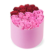 An opulent, heart-shaped expression of roses in a light pink matte round gift box. The top surface forms a crisp heart, with the upper lobes built from about a dozen deep crimson roses, tightly clustered to delineate the curve. The lower section fills with many soft blush pink roses, completing the heart with warmth and balance. Each rose is fully opened, petals curling inward in velvety spirals that give the surface a plush, uniform texture. The box is pale pink with a smooth matte finish, its round silhouette inviting a gentle touch, and the clean white background makes the colors sing. This intimate gift radiates romance, ideal for Valentine's Day, anniversaries, or a thoughtful gesture for someone in Clerkenwell or nearby Islington, Holborn, or Finsbury. The piece speaks of care and celebration, a premium box designed for same-day delivery across central London. It sits well on a small dining table or beside a bed, a keepsake of affection that remains attractive long after the first moment of surprise.