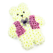 In this photograph, a teddy bear-shaped floral tribute is displayed against a simple white background, its gentle character brought to life through meticulously placed flowers. The bear's body is completely composed of creamy white chrysanthemums, each blossom pressed closely together to form a thick, luxurious layer of petal fur. From the rounded ears and softly domed head to the compact arms and little feet, the form is carefully sculpted so that the silhouette is instantly recognisable as a cuddly toy. The centers of the blooms carry faint touches of pale yellow, adding warmth and a lifelike softness to the otherwise snowy appearance. Two dark, bead-like eyes and a small triangular nose are positioned to give the bear a tender, open expression, with a subtle suggestion of a smile that feels quietly reassuring, like a companion for difficult moments. Across its chest, a vivid waistcoat effect is created in deeper pink and mauve flowers, their richer tones and fuller petals giving the impression of a neatly tailored vest. The colours glow gently, as if catching light from a nearby window overlooking one of Clerkenwell's calm side streets. At the neckline, a wispy bow of purple netting fans out, translucent and delicate, adding an extra touch of personality and care. The absence of any other objects or background distractions keeps full attention on the floral artistry and the emotions it represents. Often chosen for children's funerals, remembrance services, or tender goodbyes within the Clerkenwell community, this floral teddy bear conveys innocence, comfort, and a loving, protective presence.